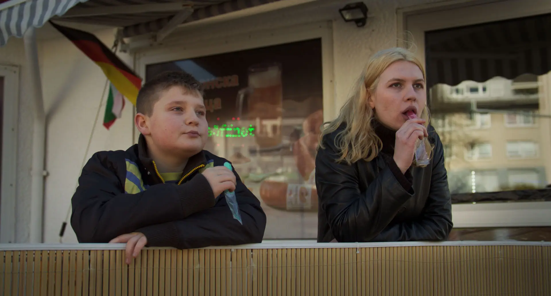two children eating and watching